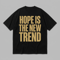Hope Is The New Trend statement tee - bold Antique Gold type on Void Black - Hope Monroe merch